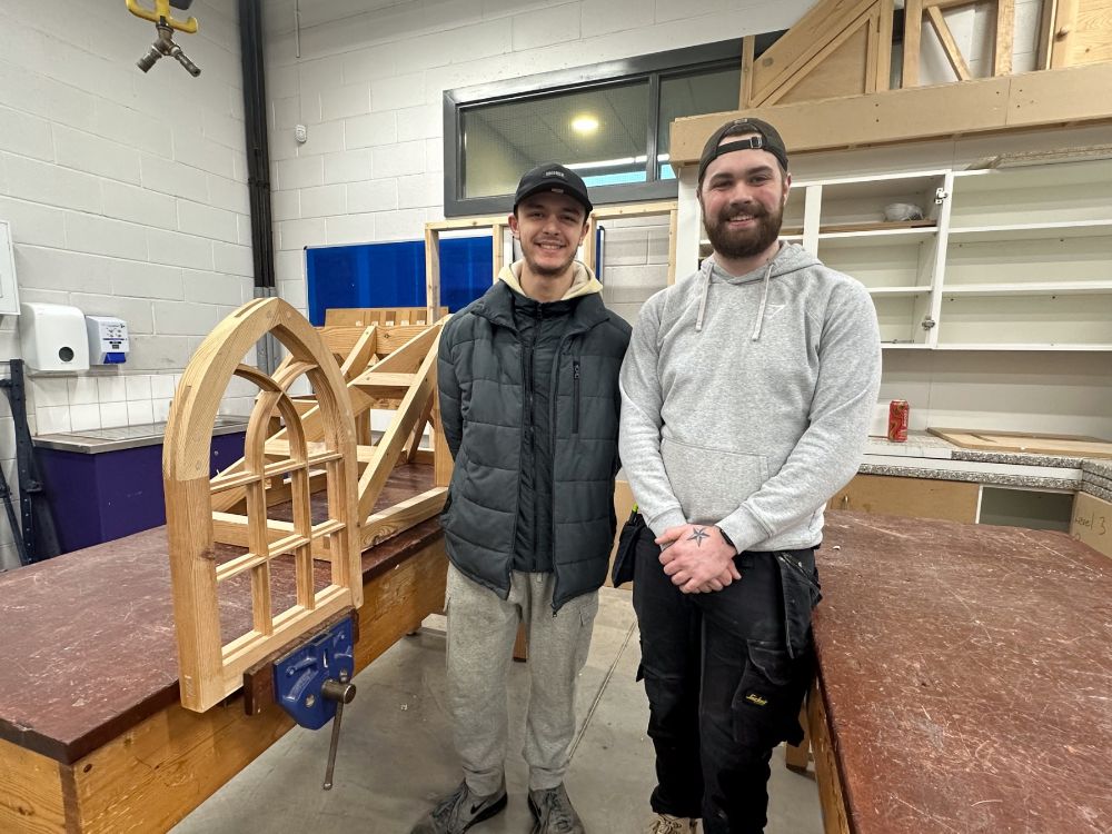 Visitor to SERC Lisburn Campus is shown the joinery workshop by  SERC Apprentice Taylor Simpson