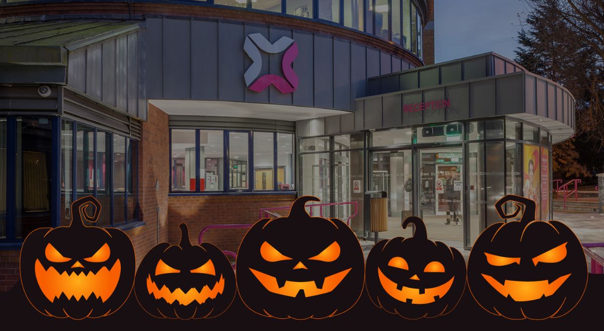 Picture of Bangor campus at night with illustrative black pumpkins with orange eyes and mouths