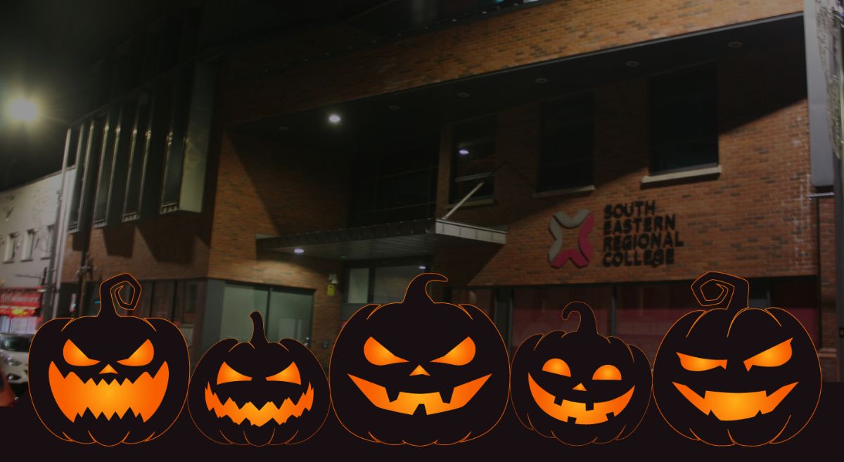 Picture of Lisburn campus at night with illustrative black pumpkins with orange eyes and mouths