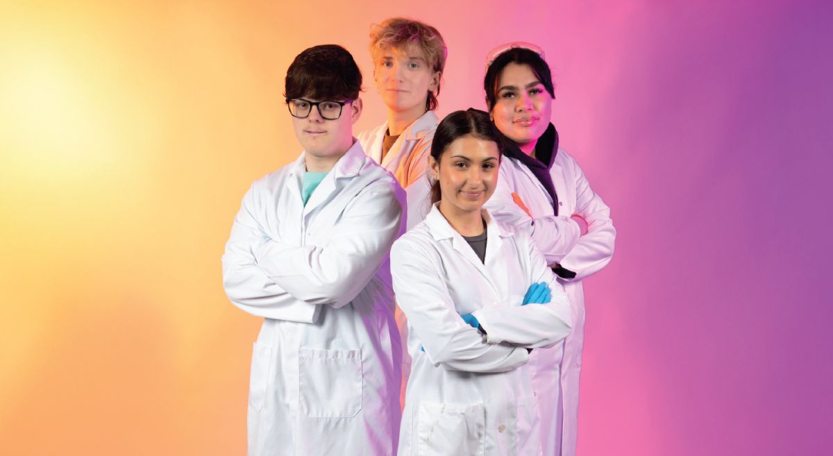 Two male and two female students on colourful background