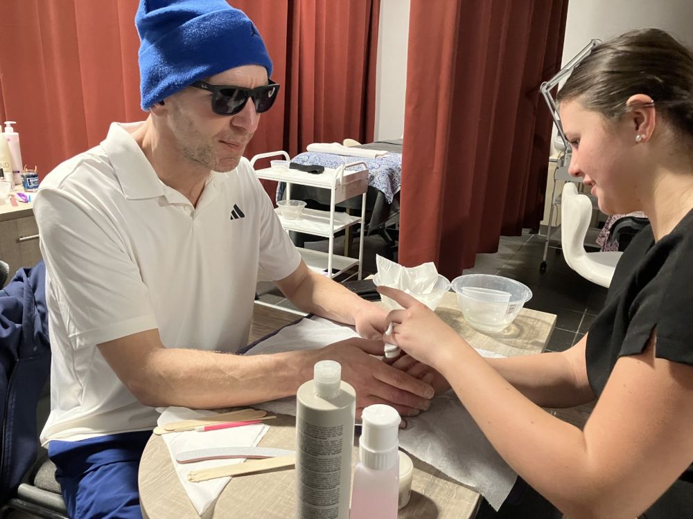 SERC tutor Declan McClure enjoys a hand and arm massage delivered by Level 2 Beauty student Anna Green (16, from Lisburn) during the staff wellbeing and pampering day at the SERC Lisburn Campus.