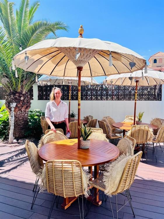 Students working abroad in an outside restaurant