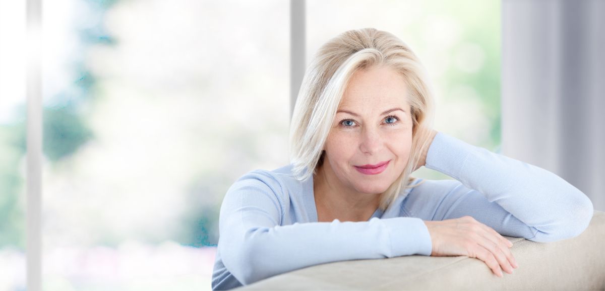 A middle-aged woman smiling at the camera.