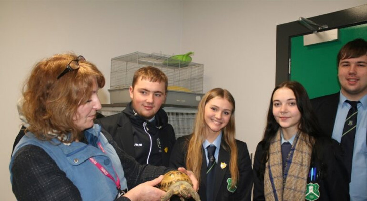 Gill Cave (SERC) shows Sheldon the Tortoise to visiting students from Forthill Integrated College