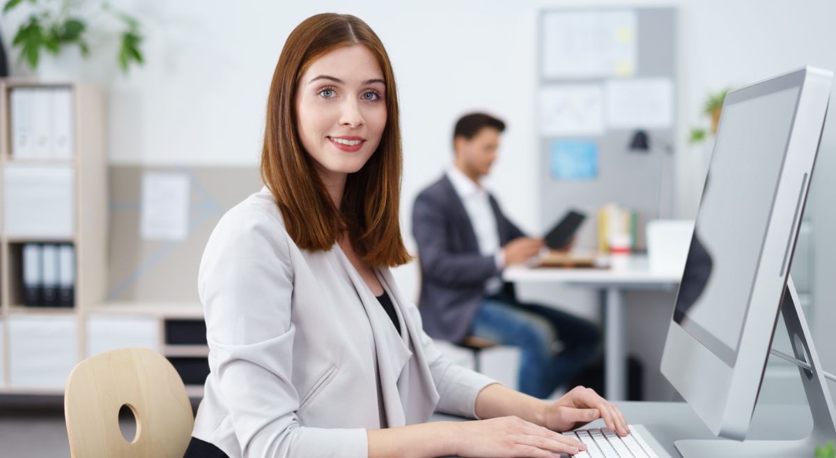 A woman working at a computer.