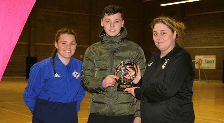 3 people presenting an award