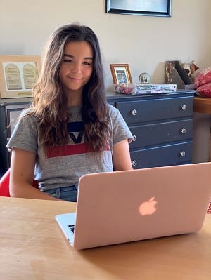 Student studying at home with laptop