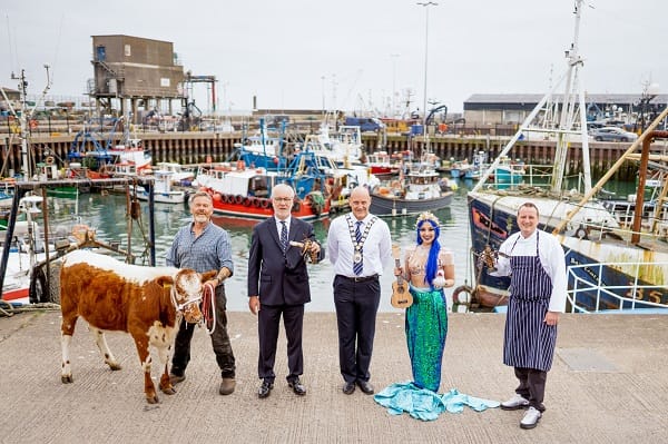 A cow and a mermaid pictured with 4 people at Portavogie Harbour!