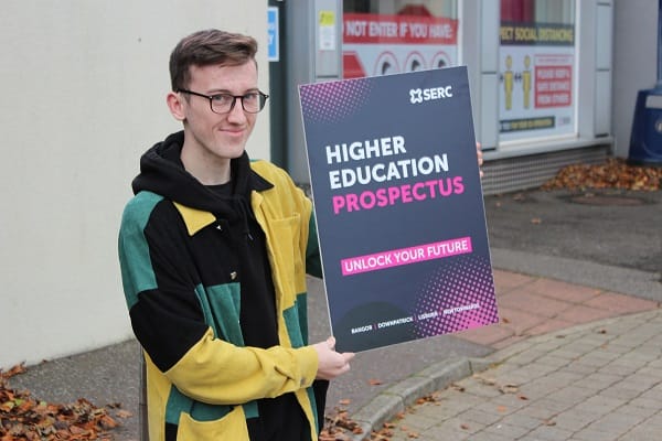 Matthew Fairley, from Newtownards, is completing the HNC in Healthcare Practice at Newtownards with prospectus cover promotion board.