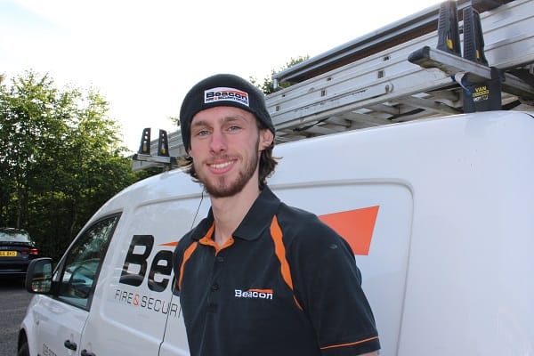 Peter Smylie in Beacon work livery standing beside Beacon van