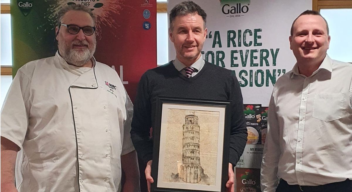 Brian Magill, with Jason Morrison MD Riso Gallo MD, who was presented with an original print of the Leaning Tower of Pisa by Katie Robinson, 18, from Newtownards, Level 3 Technical Diploma Art and Design, and Paul Mercer, Deputy Head of School. 