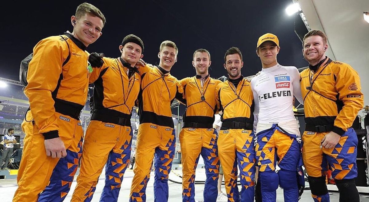 Peter with Lando Norris and members of the McLaren team.