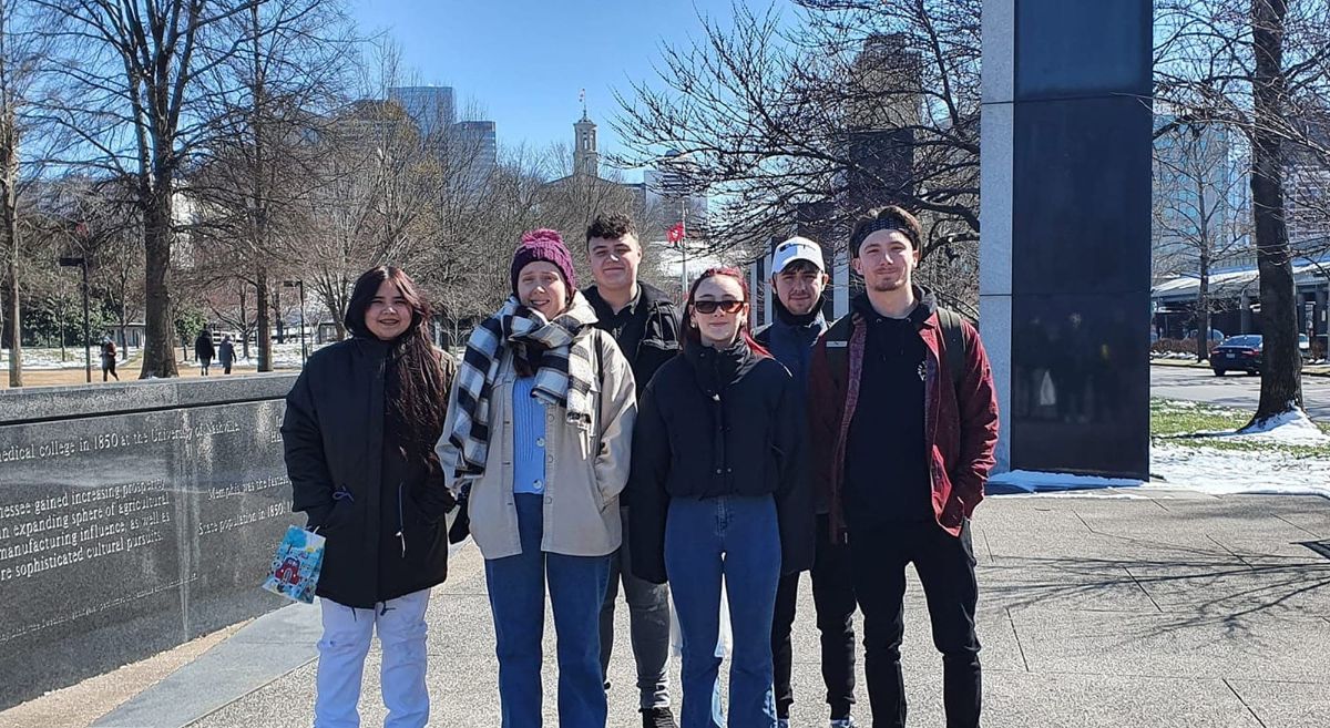 SERC students pictured on visit to Nashville with city skyline in background.