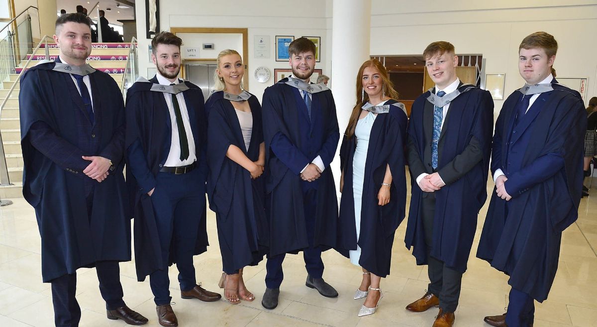 Group of 7 LJMU graduates in gowns