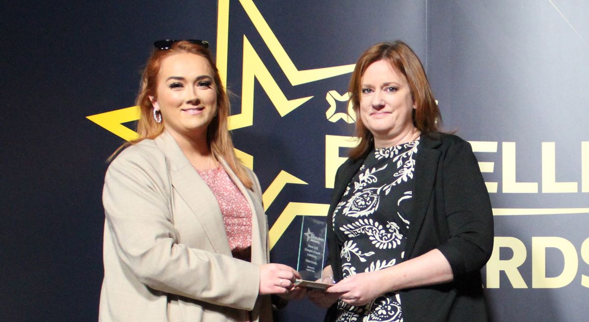 Elaine Snoddy, (right) Senior Customer Services Officer, Champion of Health & Wellbeing presented by Kathryn McCloskey, Inspired 2 Care