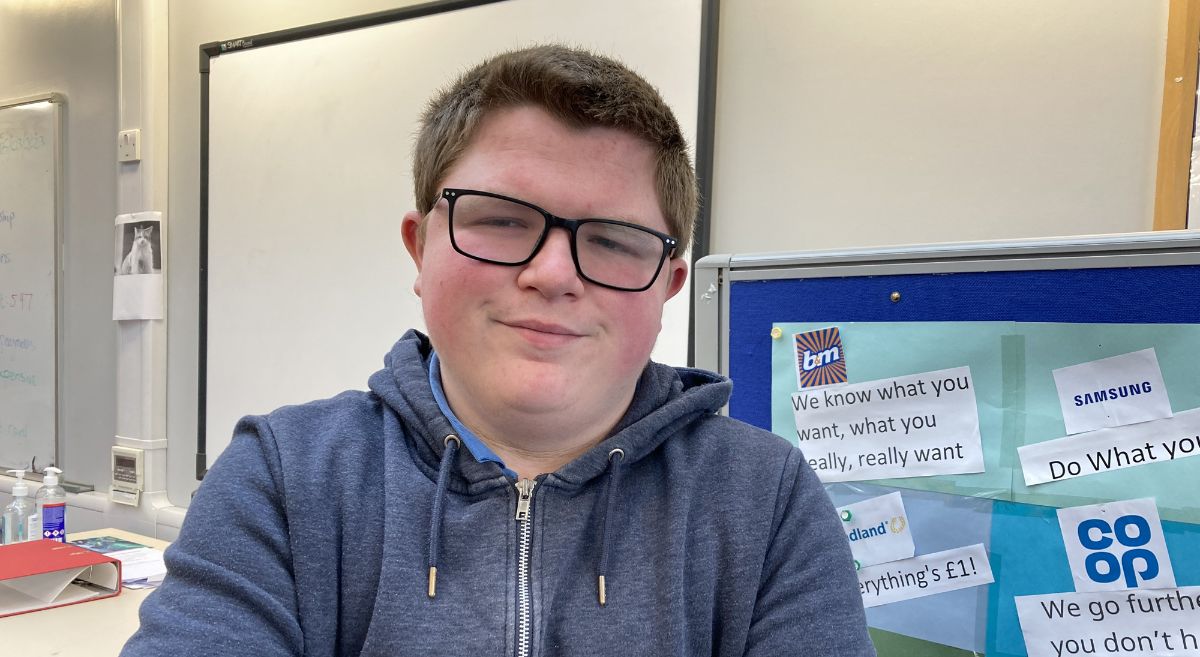 Gerard Blaney pictured in classroom with notice board in background with retail branding displayed