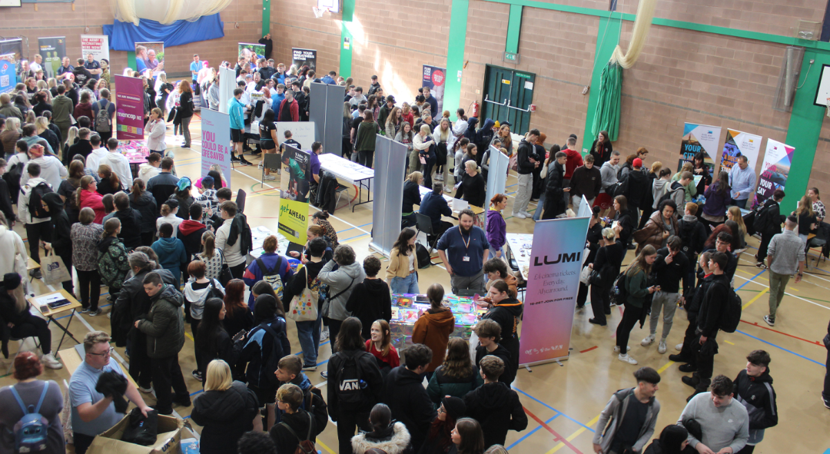 a photo during freshers displaying many students and exhibitors in a sports hall