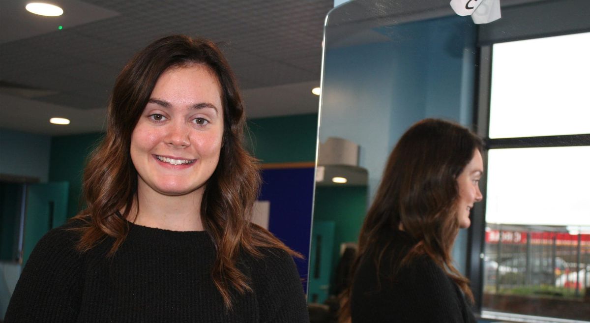 female student with reflection in mirror