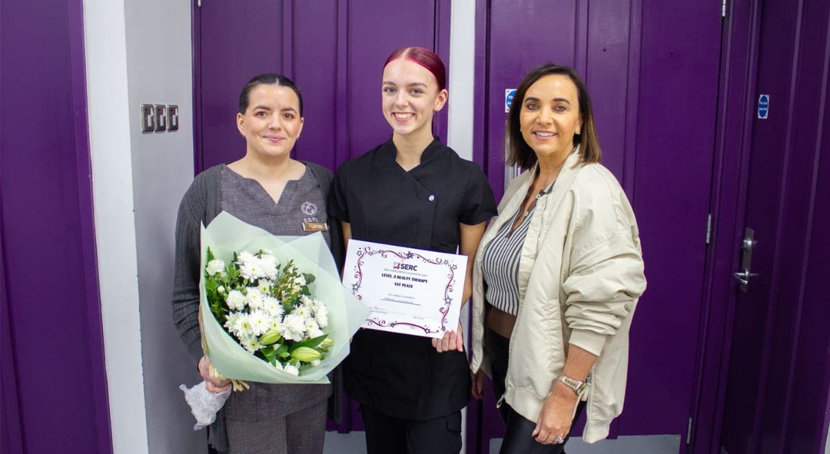 Three women smiling at the camera.