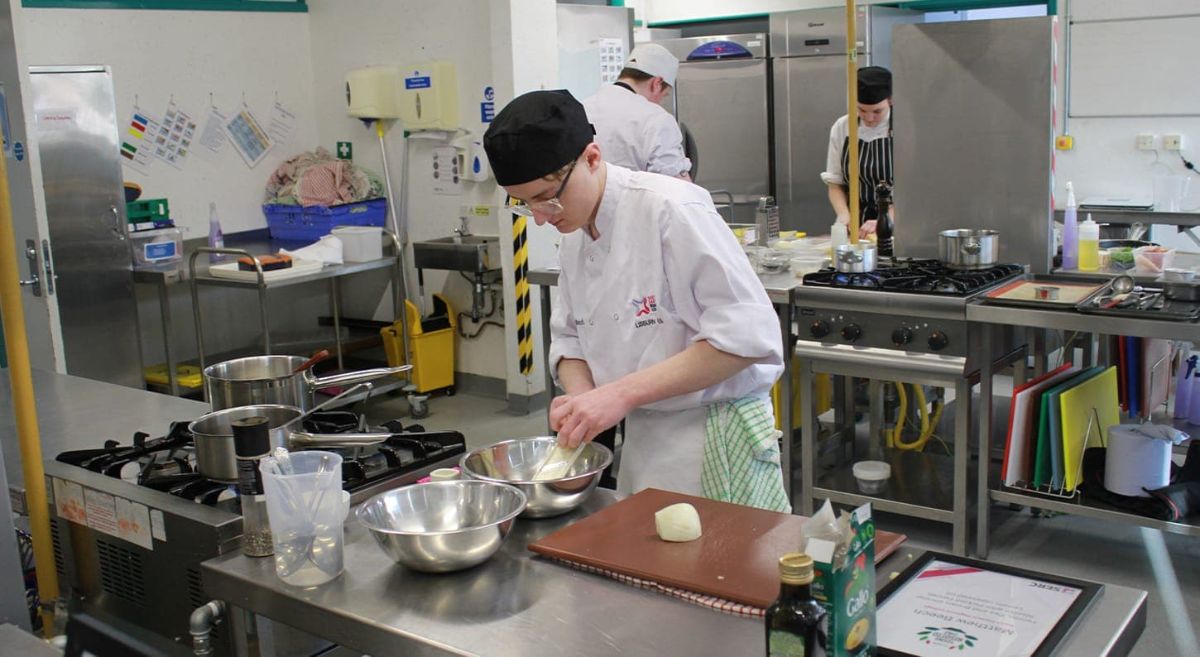 Young male student preparing ingredients.