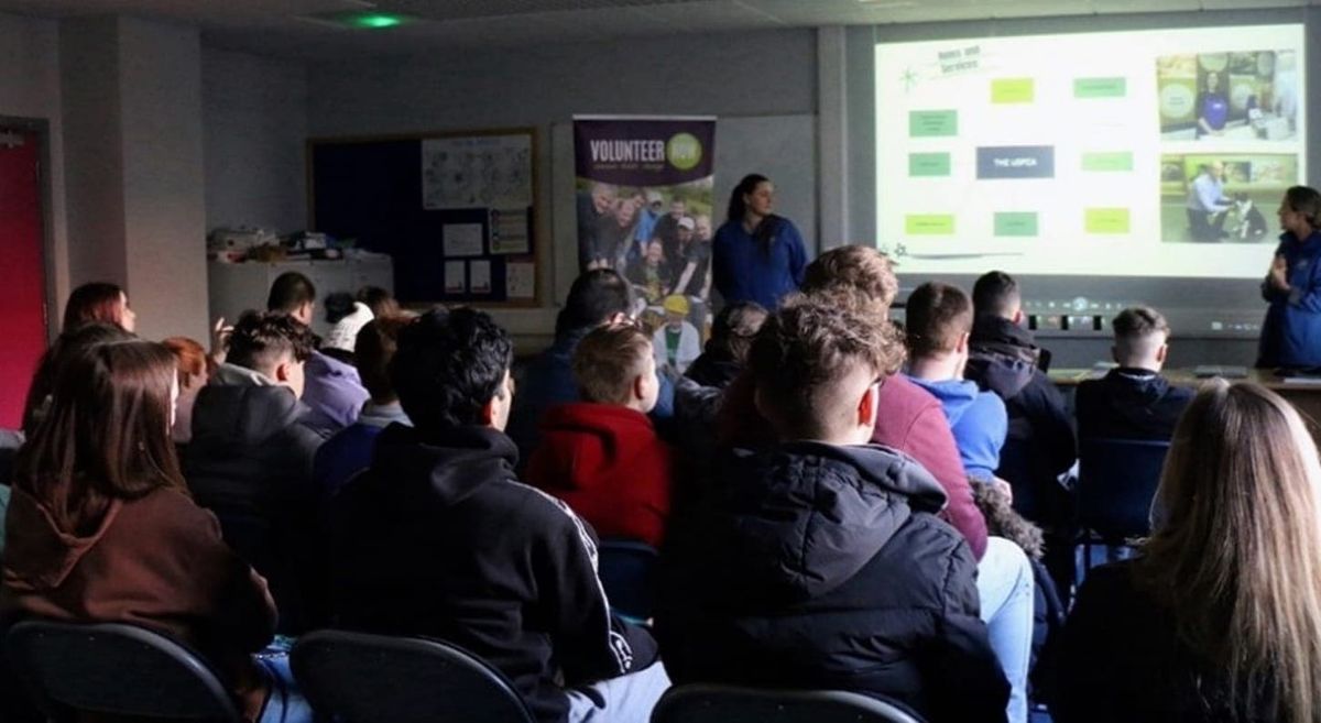 Group of people watching a presentation.