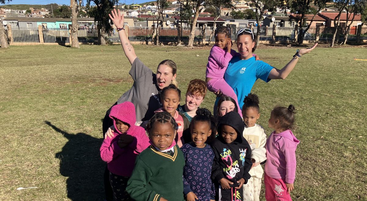 SERC Students Scarlett Jenkins and Emma McAuley in the middle with volunteers and children 