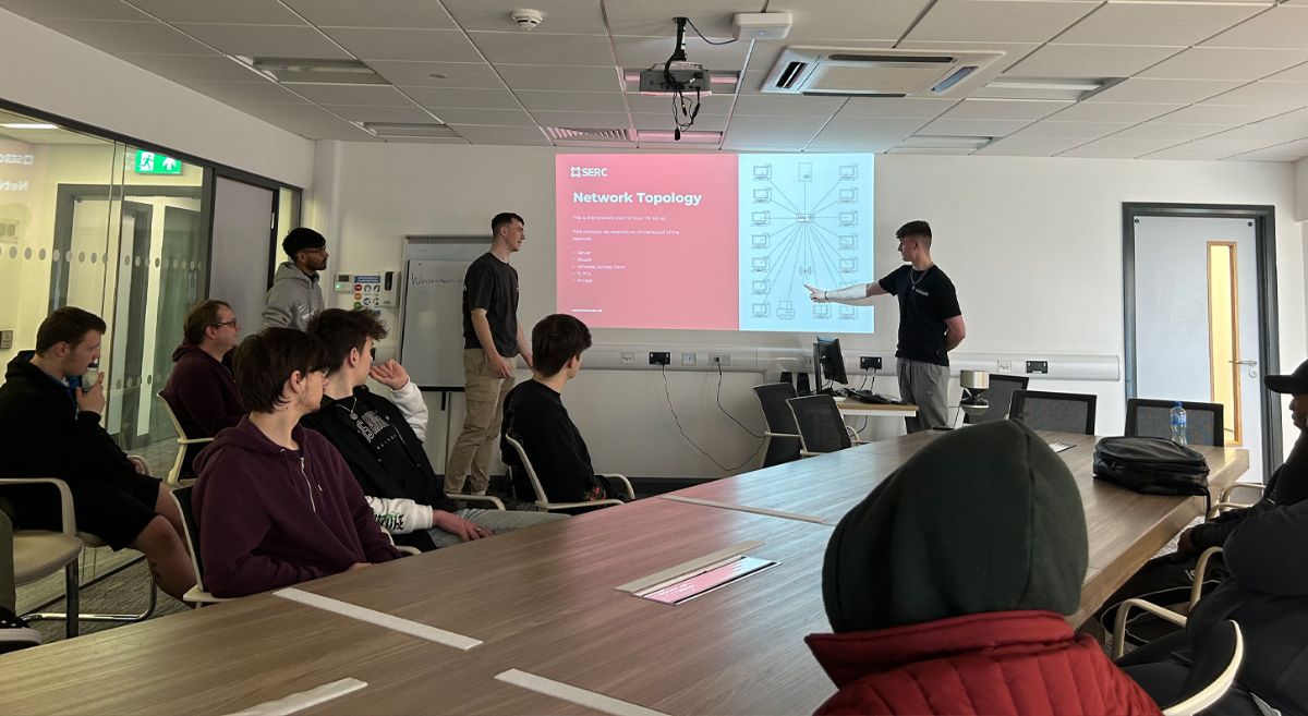 Picture of students working on setting up a computer suite