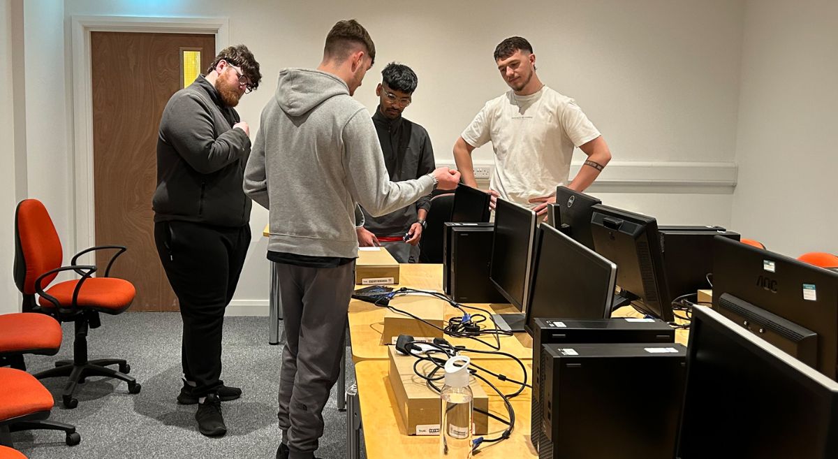 Picture of students working on setting up a computer suite