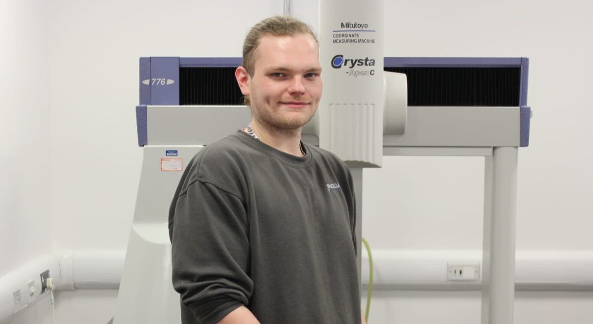 Damien Kerr in front of an engineering machine