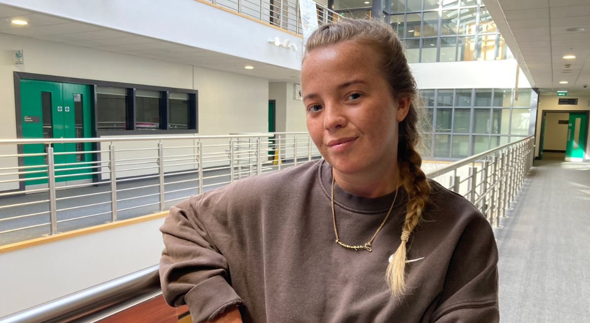 A photo of Kenzie Seaton standing beside the balcony at SERC Lisburn Campus