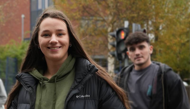 Higher Education Student Crossing th road smiling